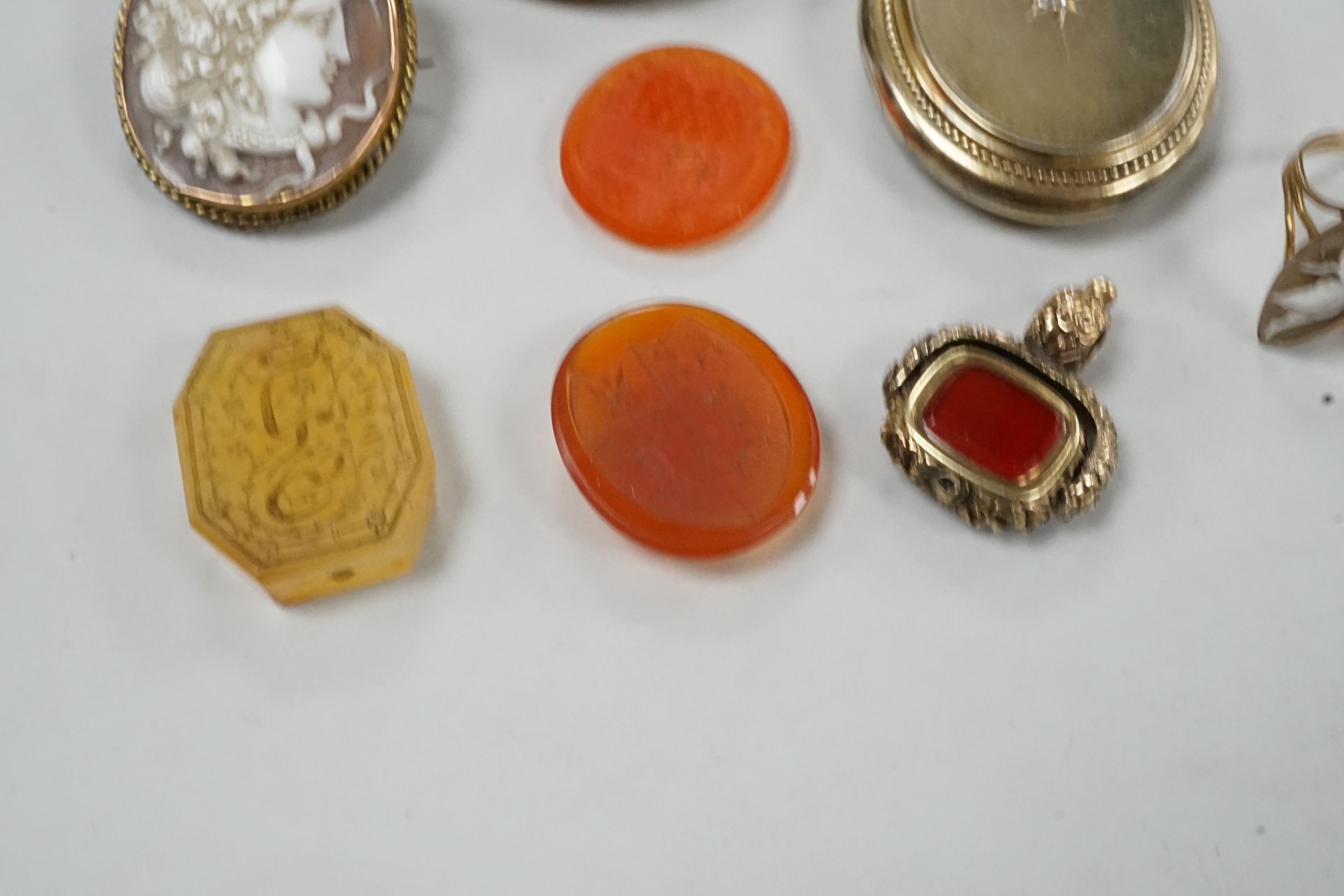 Assorted Victorian jewellery including cameo shell brooch and ring, diamond set locket, brooch, spinning fob seal and three unmounted carnelian intaglios.